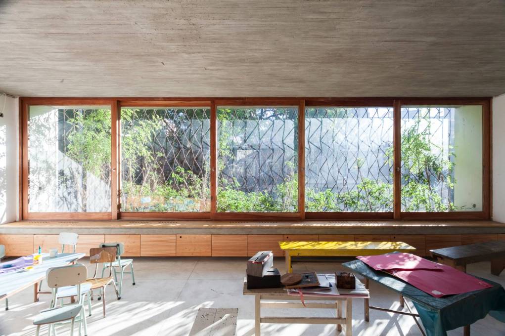 Through the almost full height windows more light enters, dappled by the iron trellis and plants outside...