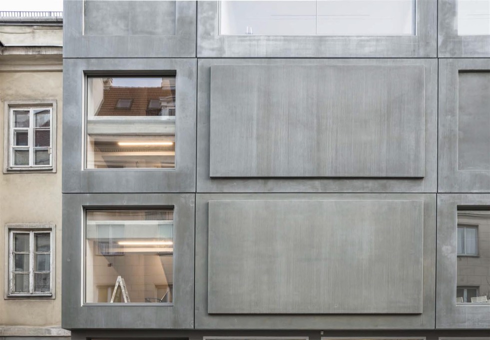 The light, four-centimetre-thick concrete panels hang off the existing structure.