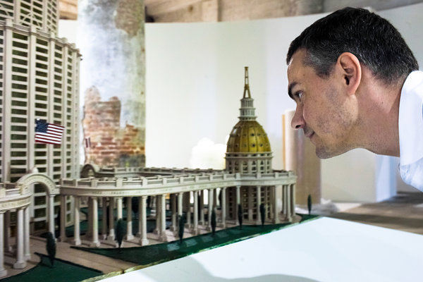 Massimiliano Gioni inspects one of the thousands of objects in his palace. (Photo: Samuele Pellecchia/NYT)