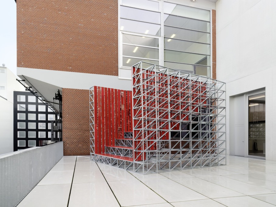 Outside, Studio Tom Emerson, &ldquo;Fun Palace&rdquo;(2014), a raked tribune made from a modular metal frame and red wooden slats, sits on the L&ouml;wenbr&auml;uareal building&rsquo;s upper terrace.