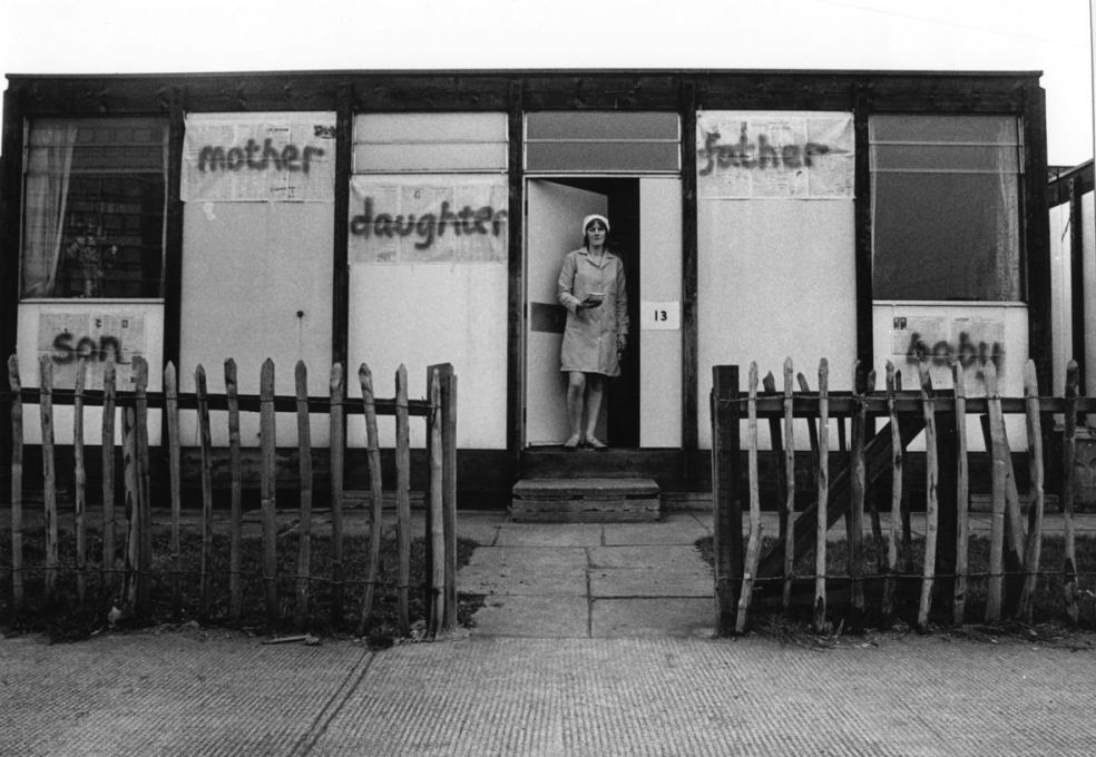 Bobby Baker with her work &lsquo;Edible Family in a Mobile Home&rsquo; at her prefab Acme house in Conder Street, E1. (Photo: Andrew Whittuck, 1976, courtesy Whitechapel Gallery)