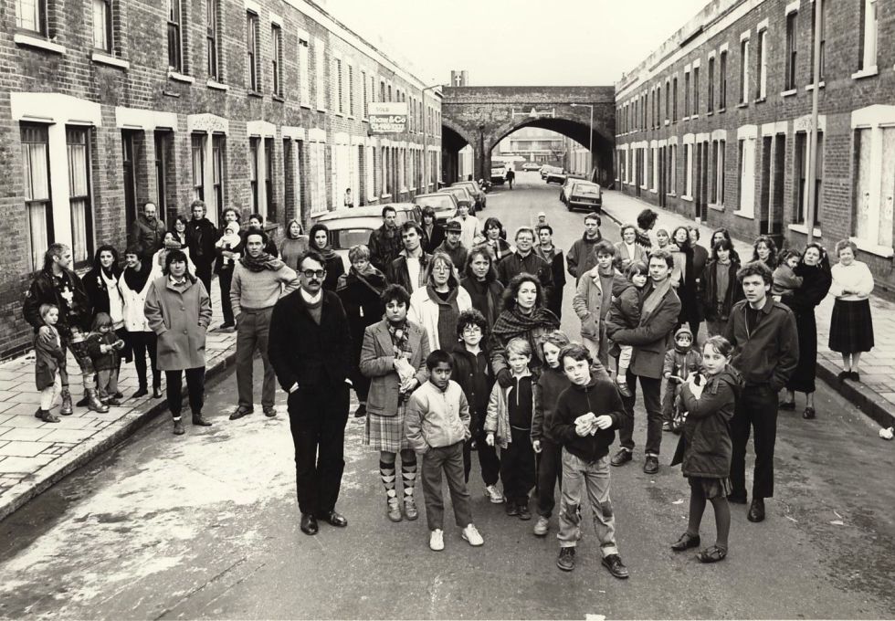 Artists and their families living on Beck Road, E8 in 1988, a street previously slated for demolition. Gallerist Maureen Paley (in dark coat in front of child at rear) opened her first gallery here in 1984. (Photo: Edward Woodman)