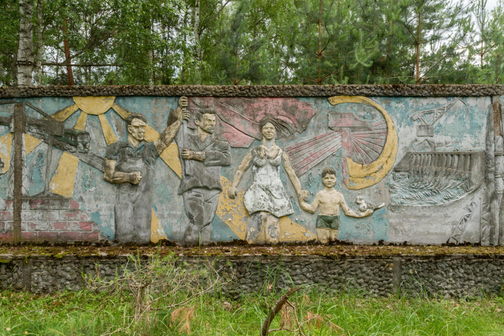 A painted relief depicts sunlight, youth and modern infrastructure.&nbsp;