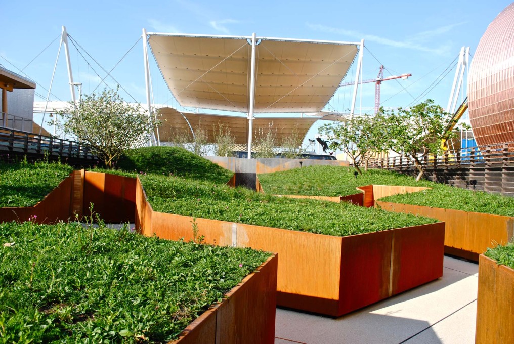 The raised &ldquo;apple orchard and meadow&rdquo; within the UK Pavilion. Luckily the Expo theme is &ldquo;food&rdquo;, you could fry eggs on the heat of the steel cladding panels. (Photo: Orlando Lovell)