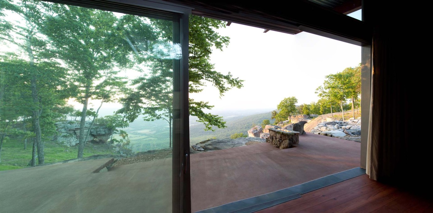 The house orients north with an all glass wall that acts as a camera lens, focused on the valley below.