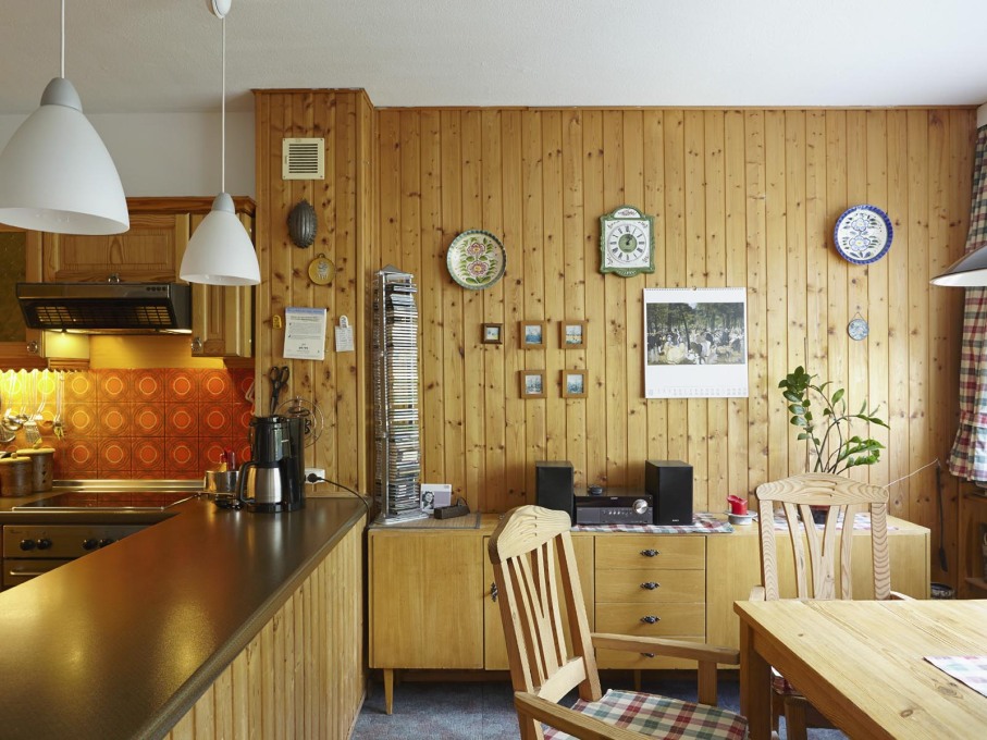 The B&auml;tz apartment features many historical layers, like the 1980s wooden panels in the kitchen area.