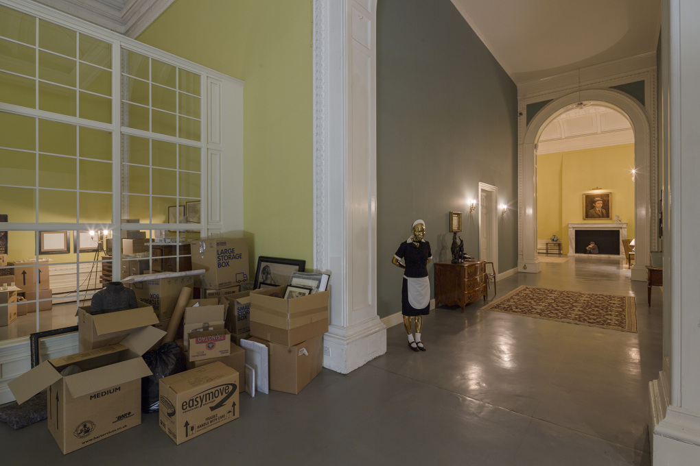 ...to impending bankruptcy. Packing cases await the clearance and sale of the house - as does a scary golden-faced maid. &copy; Elmgreen &amp; Dragset, photo: Anders Sune Berg, courtesy the artists and Victoria Miro