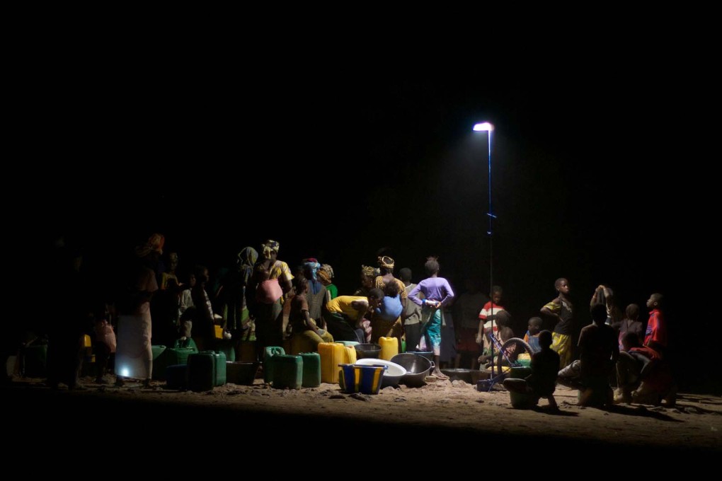 Women collect water from a fountain at night in a Malian village. (All photos&nbsp;&copy; Matteo Ferroni)