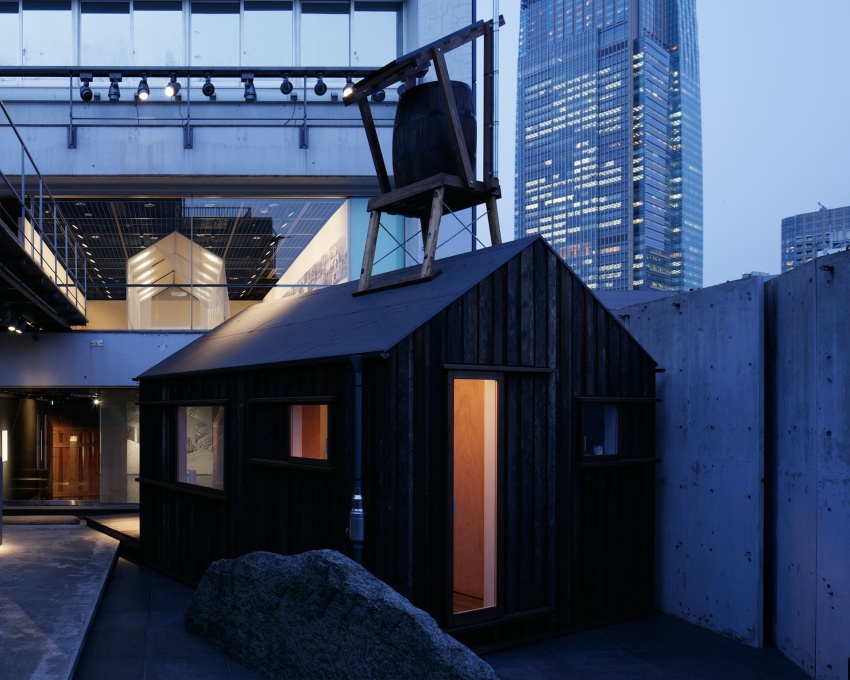 Yoshifumi Nakamura's&nbsp;Hanem Hut at dusk, its door ajar, its simple form and the glow from inside, an invitation to dwell, underlying the poetic and pragmatic spirit that infuses the whole exhibition.&nbsp;(Photo: Nac&aacute;sa &amp; Partners Inc.)&