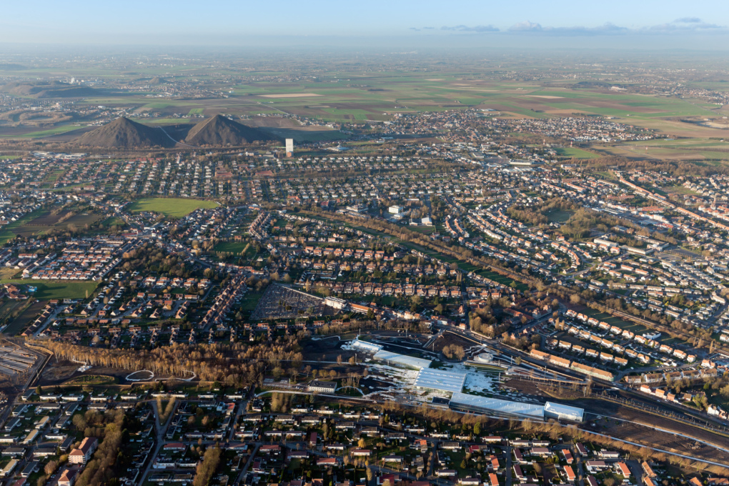 Aerial shot of Lens (population: 36,000) with the new Louvre Museum in the right foreground, built on the site of a colliery. In the background are twin spoil heaps from the long-abandoned coal industry. Photo: Iwan Baan