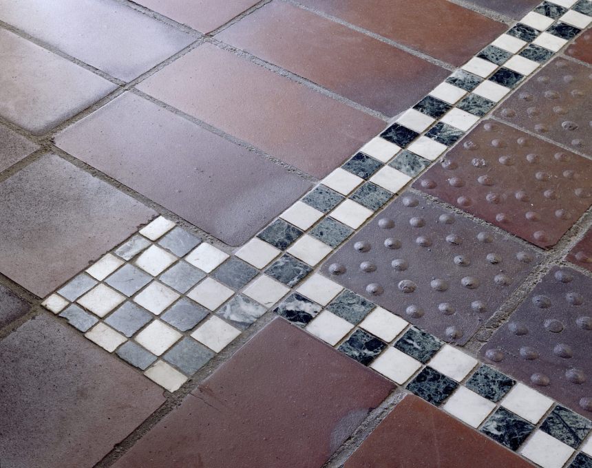 Some of the standard industrial floor tiles have been turned upside down, turning their nobbly undersides into ornament alongside the luxurious marble inlays. (Photo: Lukas Roth)