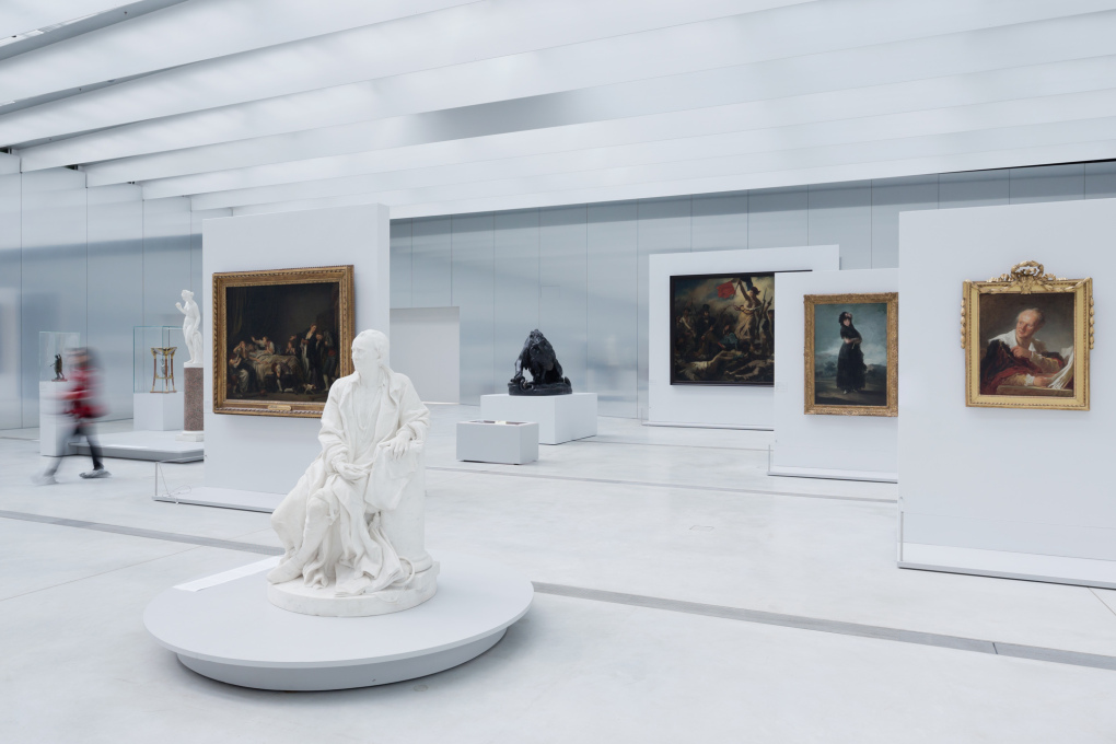 In the main exhibition spaces, work is mounted free-standing from the building's enclosure of polished aluminium, in a display that includes iconic works like Eug&egrave;ne Delacroix&rsquo;s 1831 painting "Liberty Leading the People." Photo: Iwan Baan&