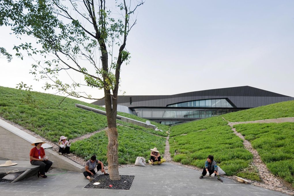 The building&rsquo;s layered forms, rising up then merging with the landscape, are carefully orchestrated to take on the collision of three powerful forces: Mr Shi&rsquo;s ambition, the needs of his workers and the demands of nature. (Photo: Iwan Baan)