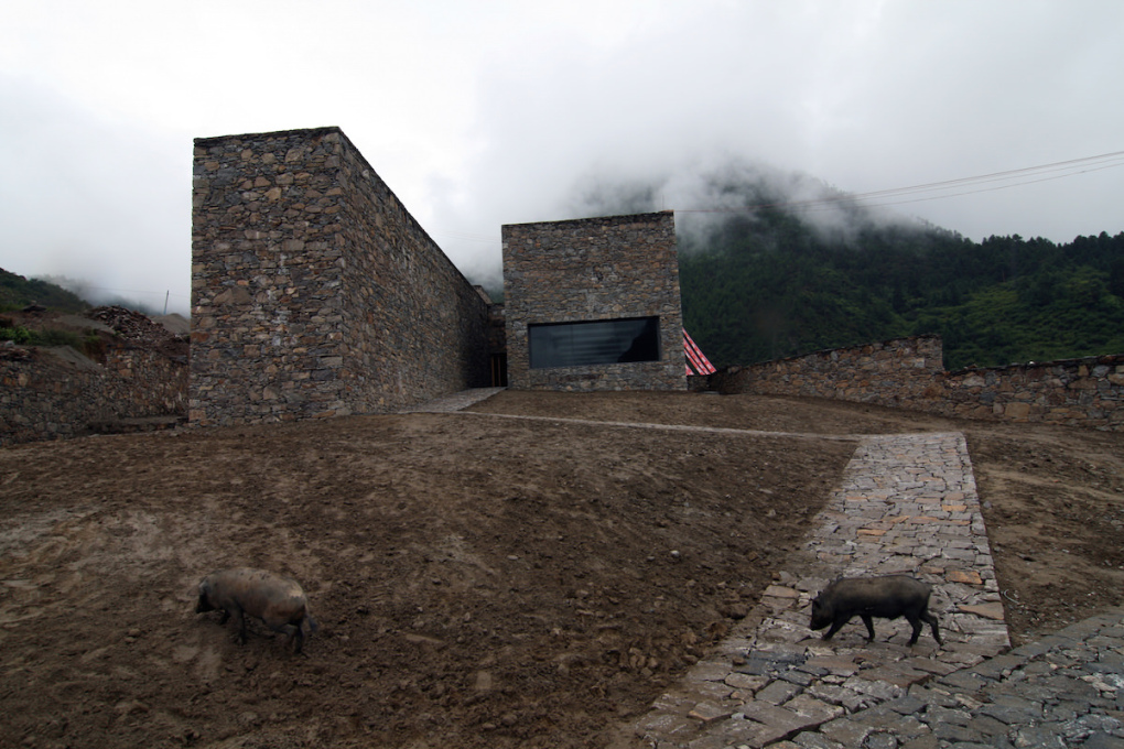 Namcha Barwa Visitor Centre, Pai Town, Tibet (2008) with some porcine visitors.