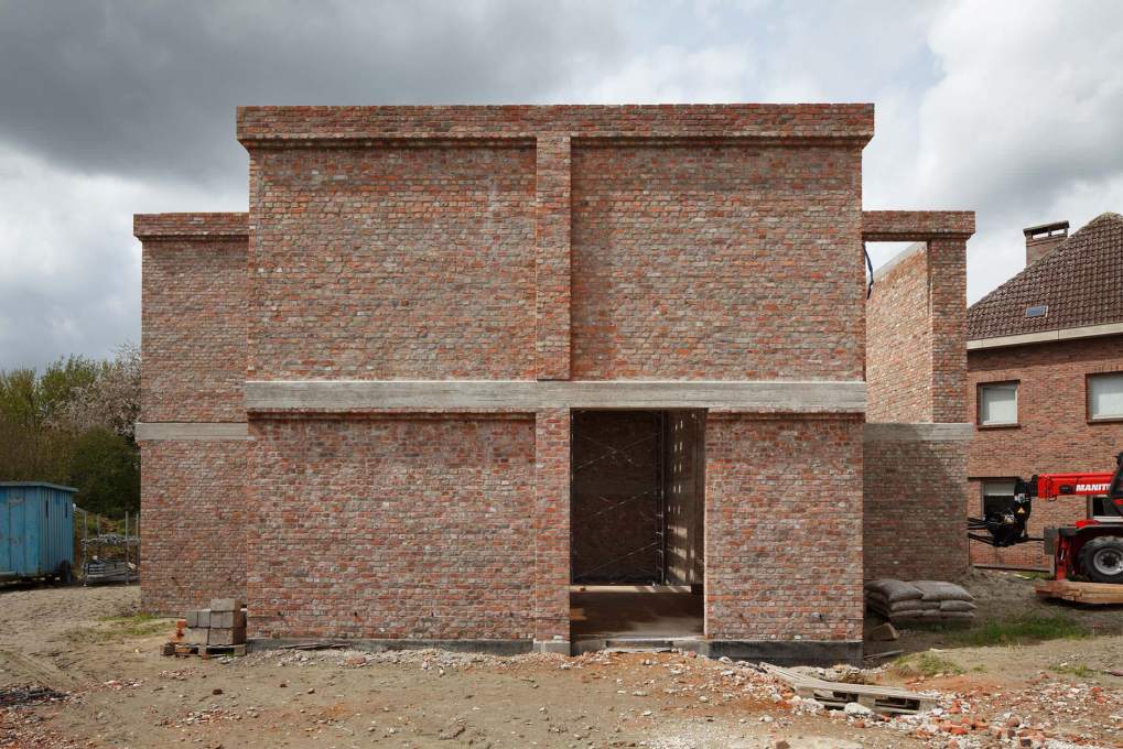 One of the raw brick fa&ccedil;ades during construction.